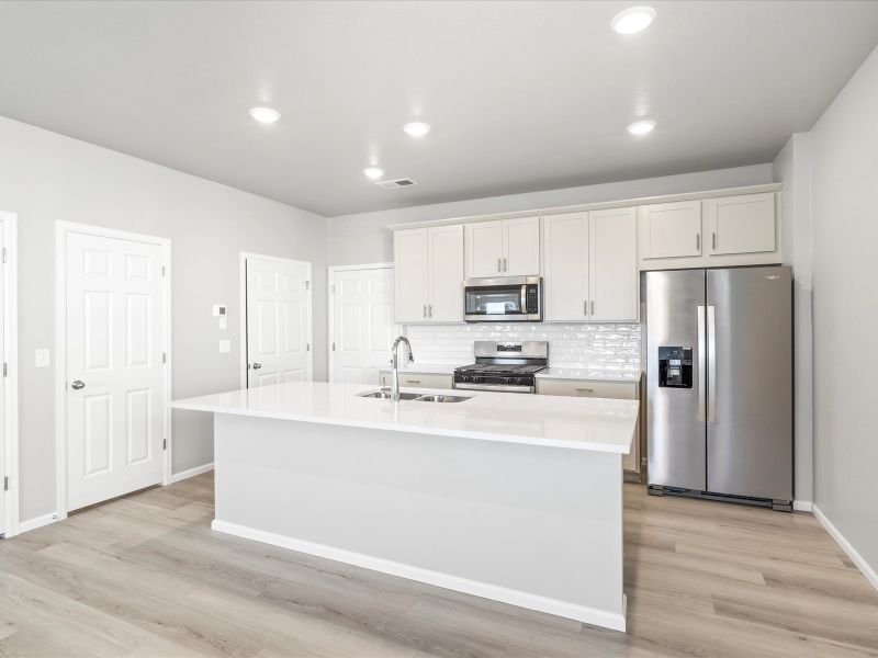 Kitchen in the Woodland floorplan at a Meritage Homes community in Broomfield, CO.