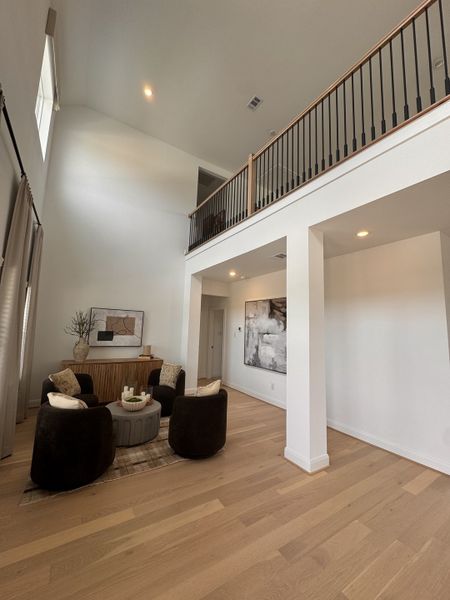 A spacious living area with high ceilings, elegant décor, and cozy seating, enhanced by natural light and modern art. A spacious living area with high ceilings, elegant décor, and cozy seating, enhanced by natural light and modern art.