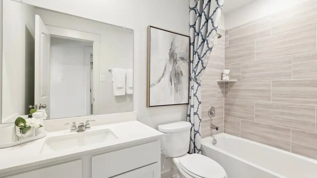 Featuring sleek cabinetry, refined tiles, and artistic accents in Still Water Lake Estates.