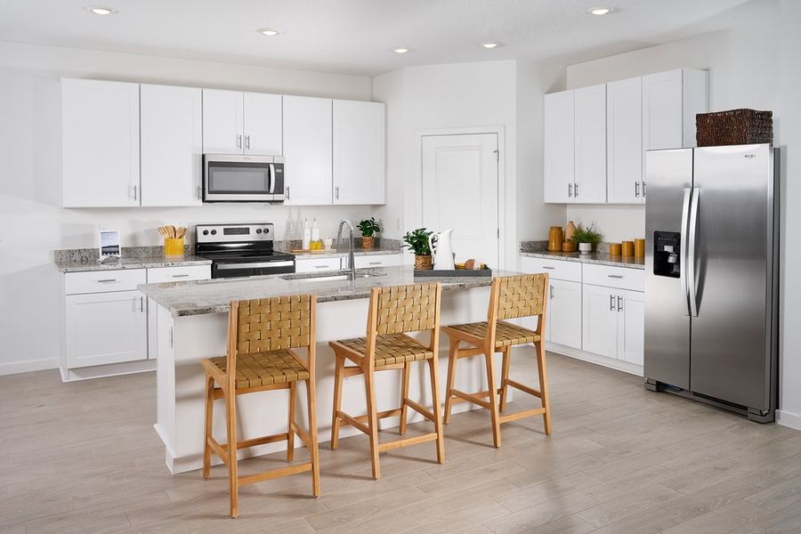 Kitchen of the Orchid plan modeled at Lakes at Bella Lago.