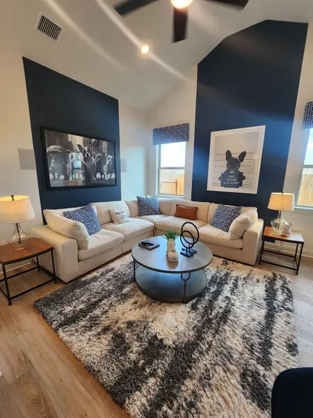 A cozy living room with a plush corner sofa, stylish artwork, and a chic patterned rug. A cozy living room with a plush corner sofa, stylish artwork, and a chic patterned rug.