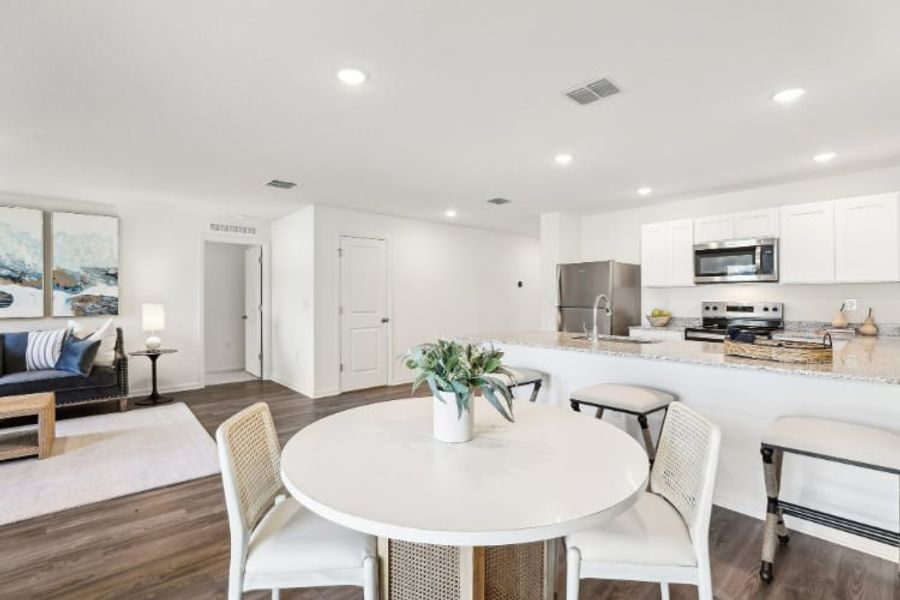 A kitchen with a dining table.