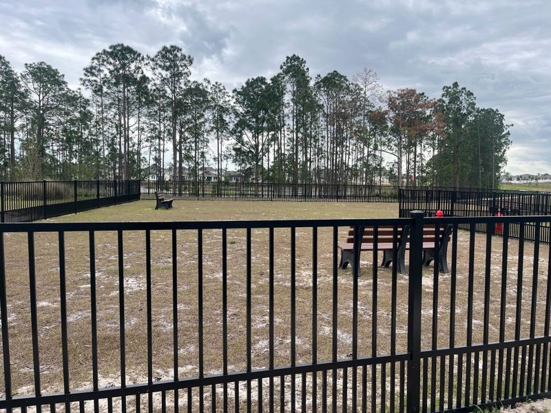 A tranquil fenced park with benches and tall trees in Harvest at Ovation - Townhomes by Rockwell Homes (Winter Garden, FL). A tranquil fenced park with benches and tall trees in Harvest at Ovation - Townhomes by Rockwell Homes (Winter Garden, FL).