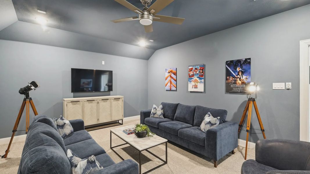 Experience plush navy seating and sleek contemporary lighting in this Ridge Crossing media room. Experience plush navy seating and sleek contemporary lighting in this Ridge Crossing media room.