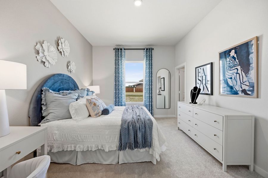 A bedroom with a large window. A bedroom with a large window.
