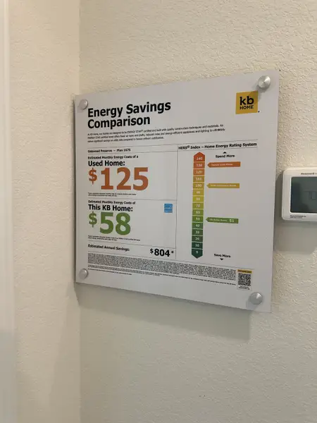 An energy savings comparison board highlighting cost-effective features in a KB Home property.