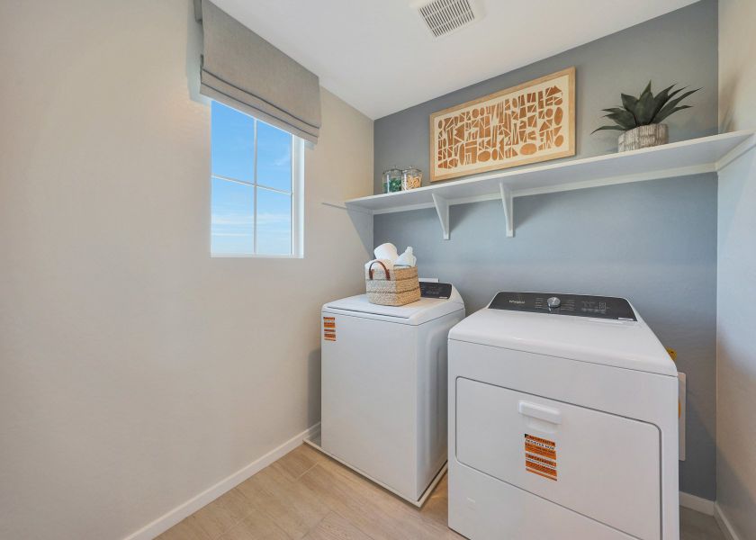 A laundry room with a washer and dryer. A laundry room with a washer and dryer.