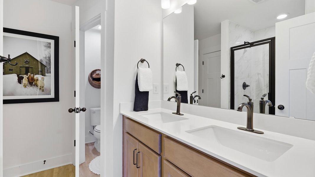 Notable primary suite with dual vanities and walk-in shower in this prime Hendersonville villa