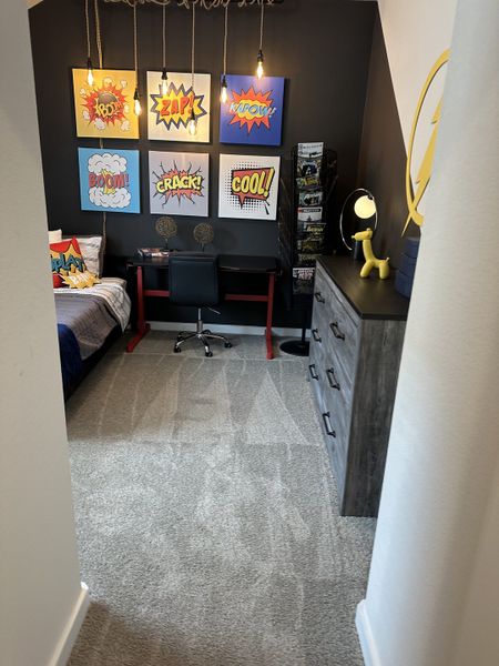A vibrant child's bedroom with playful comic art, cozy carpet, and sleek furniture. A vibrant child's bedroom with playful comic art, cozy carpet, and sleek furniture.