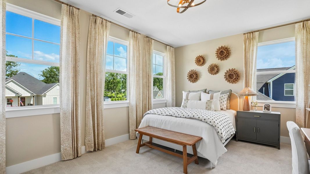 Secondary bedroom with natural lighting from windows and carpet Secondary bedroom with natural lighting from windows and carpet