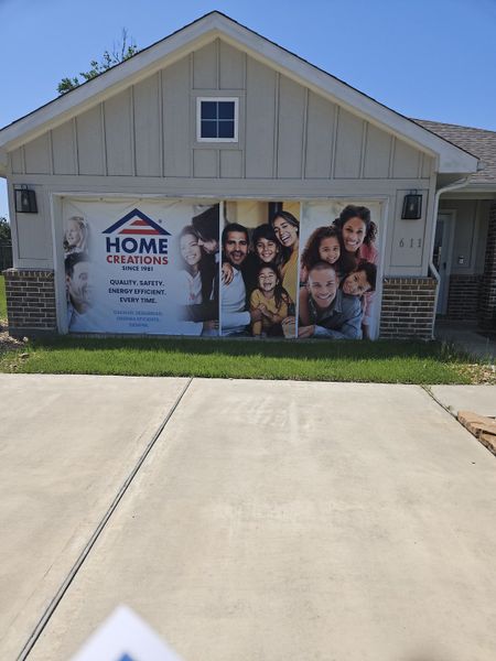 A cozy home with a bright facade and welcoming driveway in Santa Fe by Home Creations (Cleveland, TX).