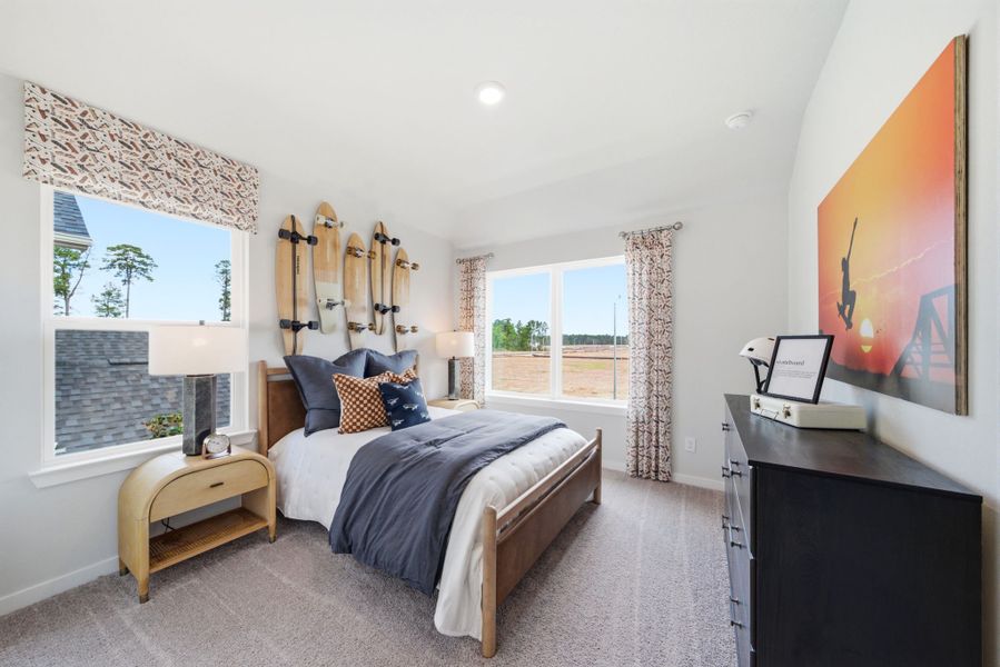 A bedroom with a large window.
