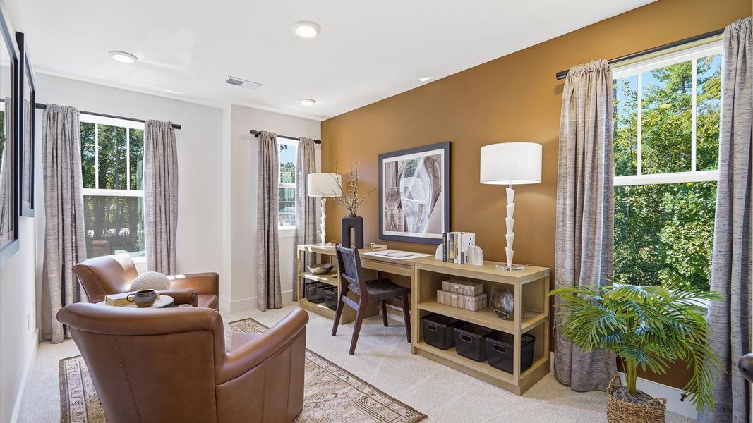 Memorable workspace with carpet floors, modern finishes, and exceptional light and flow by DRB Homes