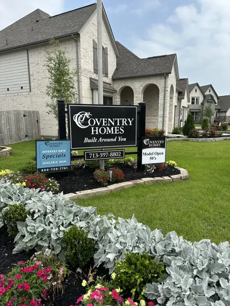Elegant brick home surrounded by lush landscaping in The Meadows at Imperial Oaks 40' - Section 20 by Coventry Homes (Conroe, TX).