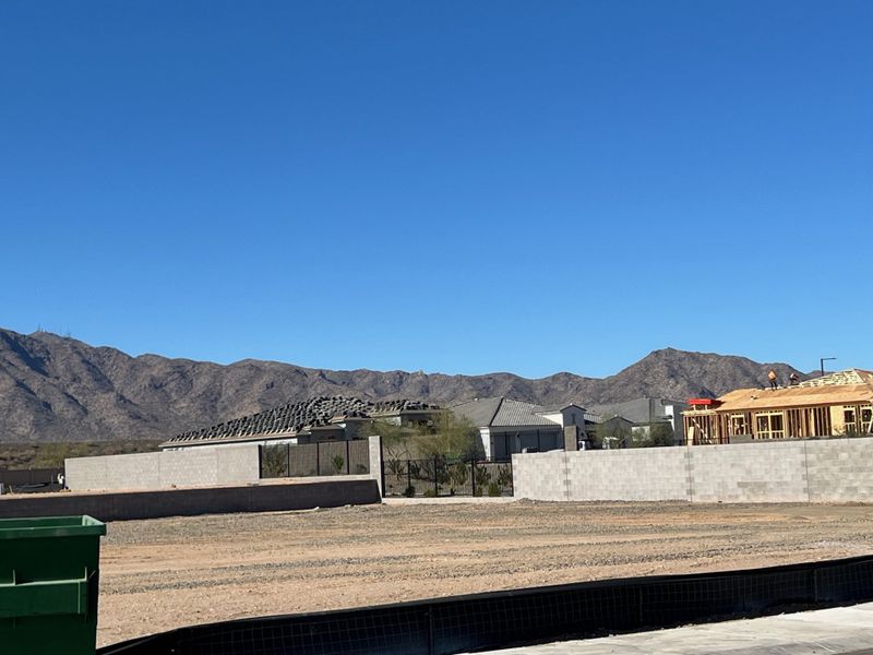 New homes under construction with mountain backdrop in Sentiero at Windrose by David Weekley Homes, Waddell, AZ.
