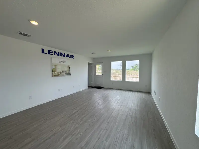 A spacious, light-filled room with wood flooring and two large windows, accented by a minimalist decor and modern style. A spacious, light-filled room with wood flooring and two large windows, accented by a minimalist decor and modern style.