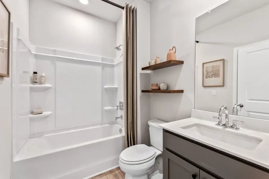 A bathroom with a tub toilet and sink.