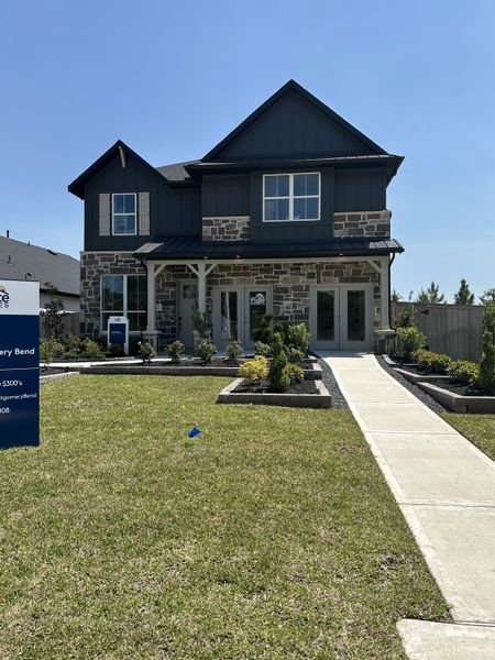 A charming two-story home with stone detail and lush landscaping in Montgomery Bend by Pulte Homes (Montgomery, TX). A charming two-story home with stone detail and lush landscaping in Montgomery Bend by Pulte Homes (Montgomery, TX).