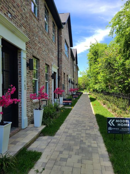Charming brick townhomes with colorful planters in 1897 Townhomes by InTown Homes (Plano, TX). Charming brick townhomes with colorful planters in 1897 Townhomes by InTown Homes (Plano, TX).