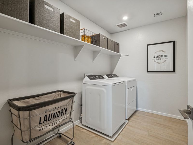 A room with a washer and dryer.