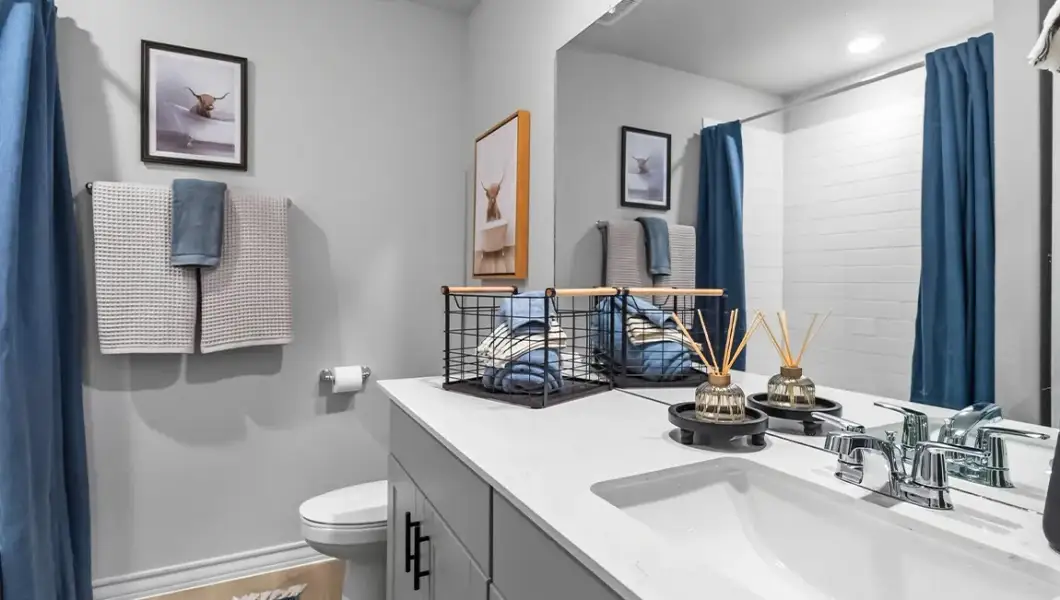 Furnished interior in a model home at The Woodlands at Medina Hills in Mico (Image 18).