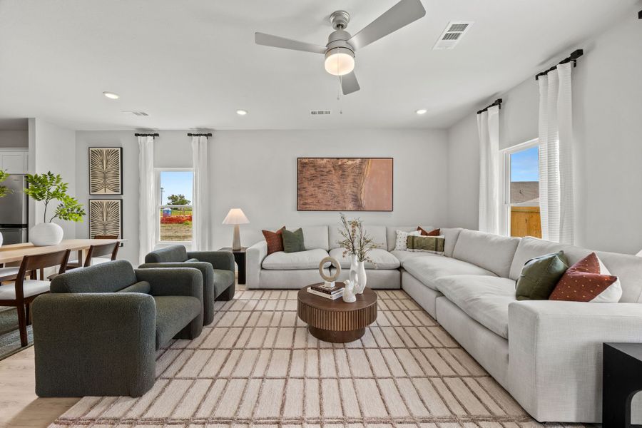 A living room with a couch and a table. A living room with a couch and a table.