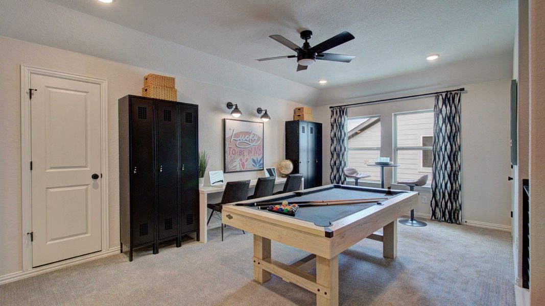 Elegant game room with modern fixtures and plush carpet in exclusive Meyer Ranch.