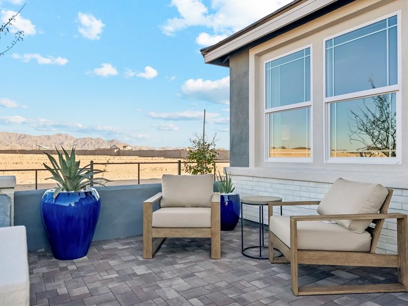 A patio with chairs and a table. A patio with chairs and a table.