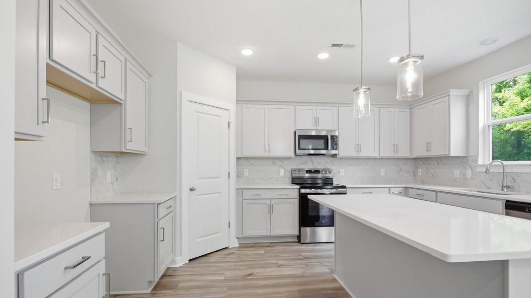 Gorgeous, clean white kitchen with quartz countertops and tile backsplash Gorgeous, clean white kitchen with quartz countertops and tile backsplash