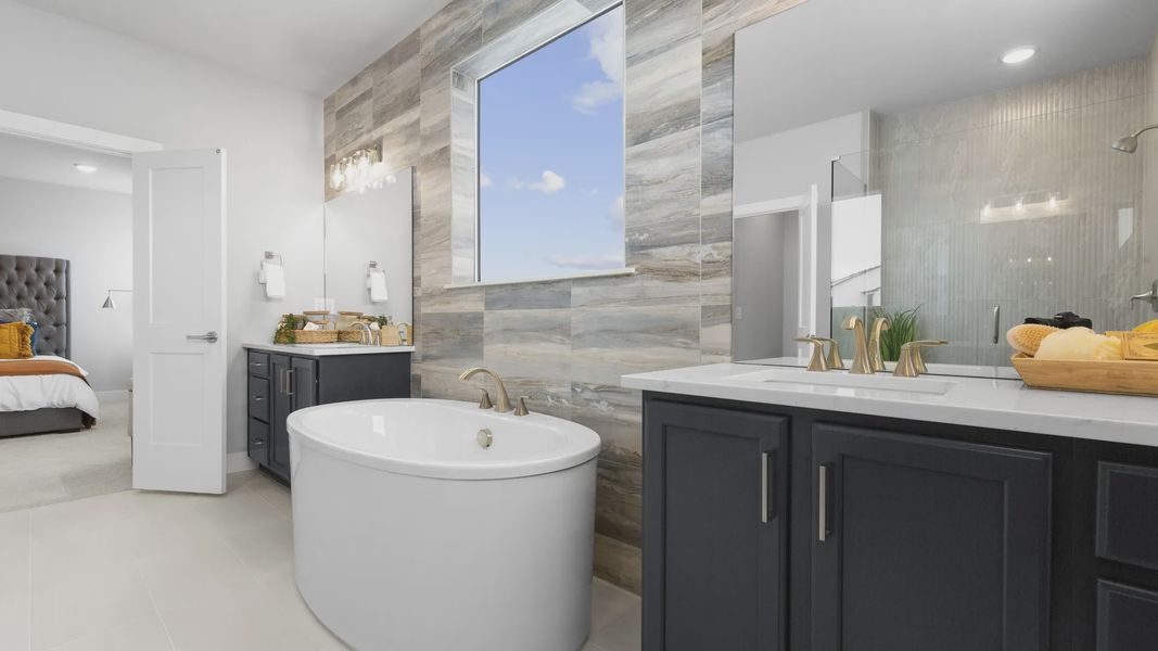 Experience elegance with a freestanding tub, marble accents, and refined fixtures in this Montaine home.