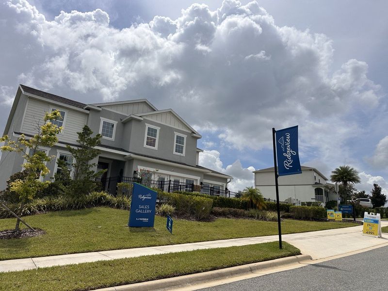 A beautiful gray home with manicured landscaping in Ridgeview by Landsea Homes, Clermont, FL.