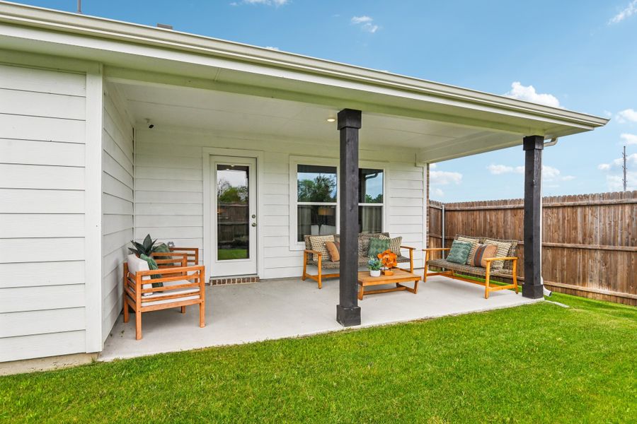 A house with a patio and a fence.