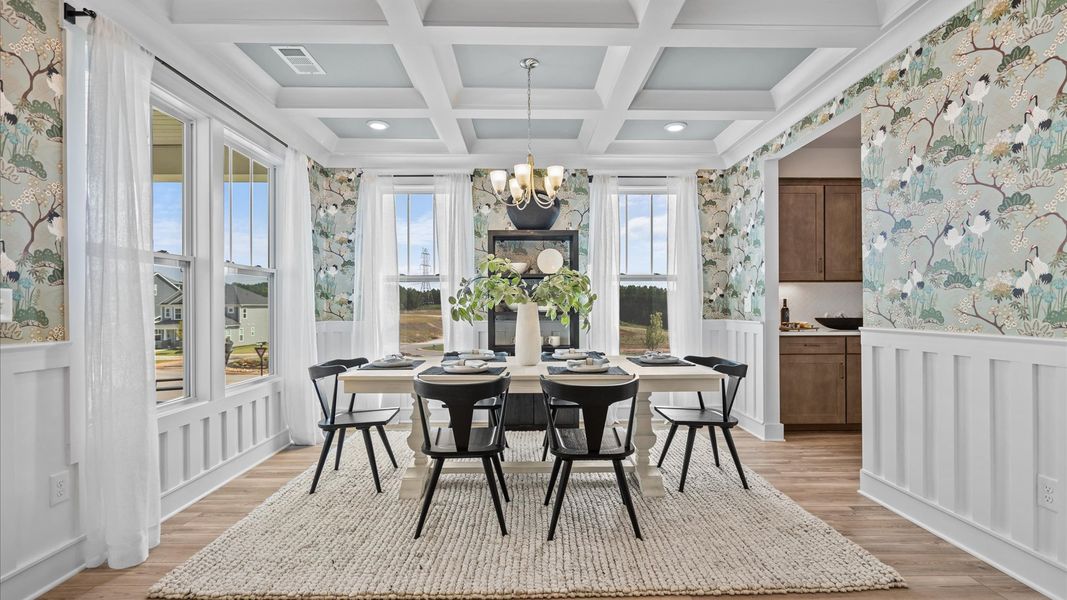 Eye-catching coffered ceiling adds charm to the formal dining space in this superior DRB Homes design