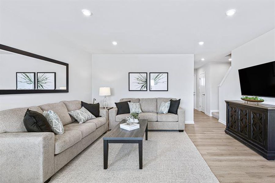 The first floor flows effortlessly, uniting living, kitchen, and dining spaces for easy living.