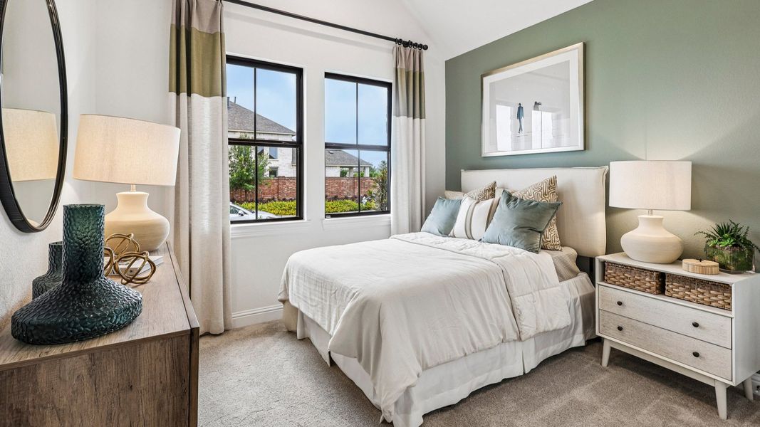 Sunterra bedroom boasts vaulted ceilings, elegant pale green accent wall, and expansive windows for airy luxury. Sunterra bedroom boasts vaulted ceilings, elegant pale green accent wall, and expansive windows for airy luxury.