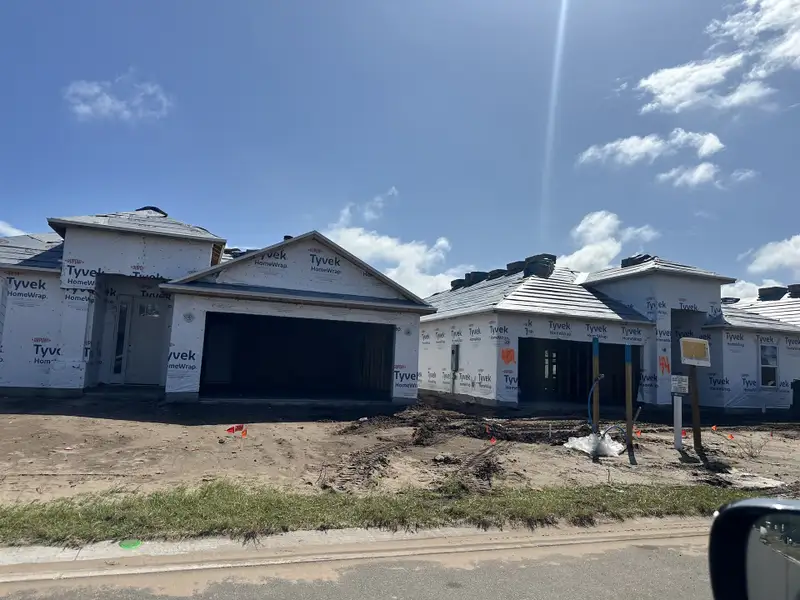 Contemporary homes under construction with Tyvek wrap in Colbert Landings by Taylor Morrison (Palm Coast, FL).