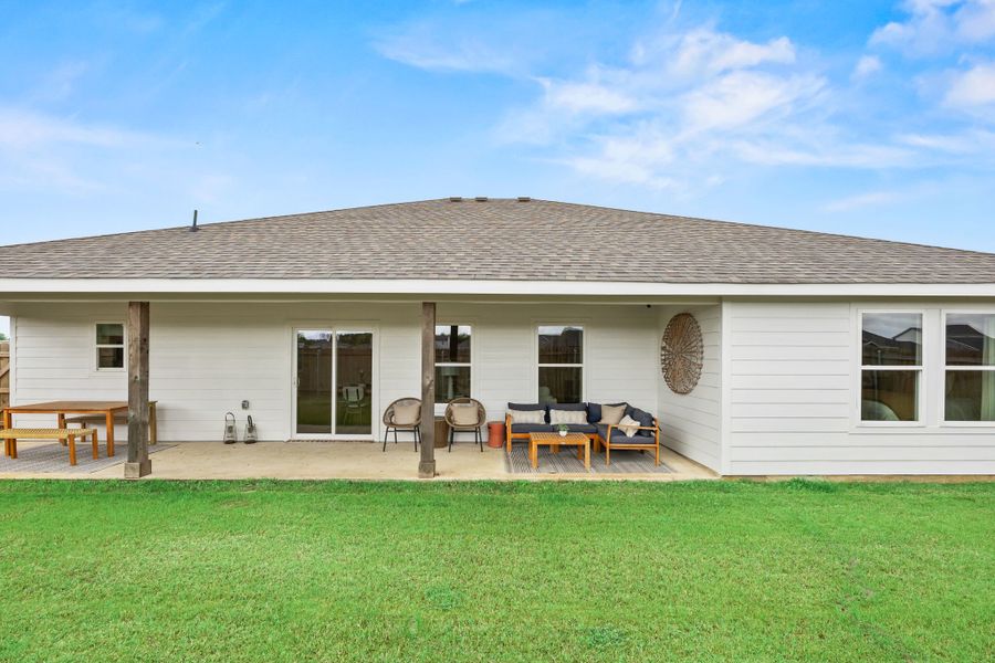 A house with a lawn and chairs. A house with a lawn and chairs.