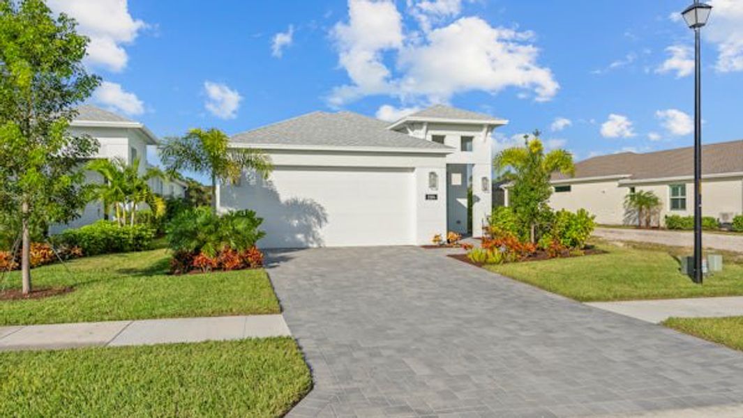 Front exterior of a home in the The Falls at Grand Harbor community, located in Vero Beach, FL (Image 47).