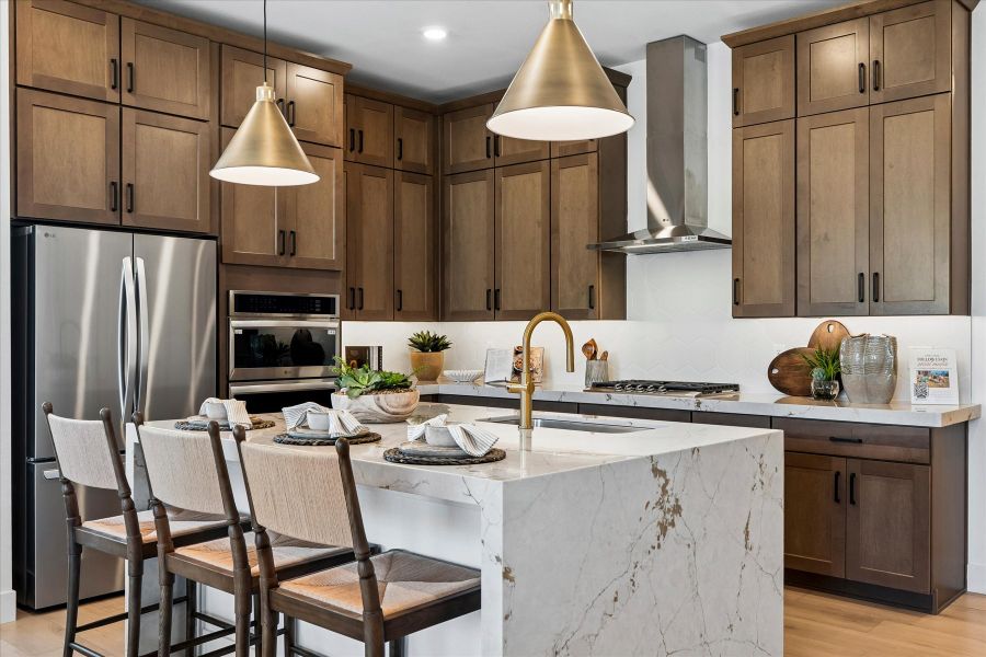 A kitchen with a table and chairs.