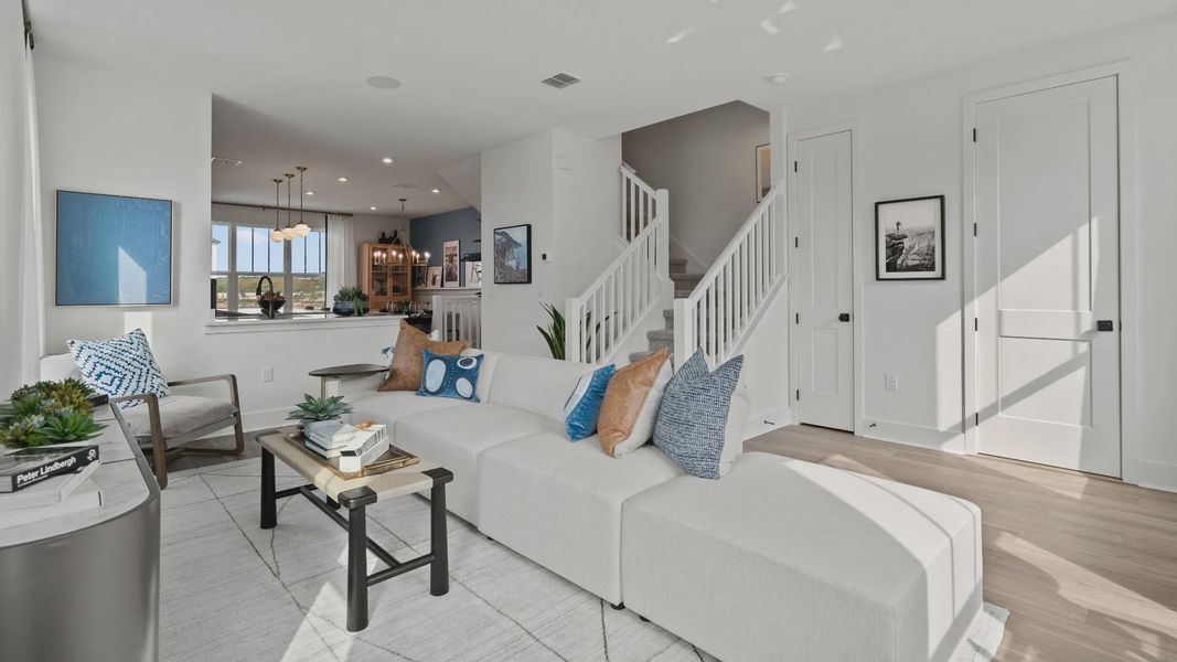 Parkview at Hamlin by DRB Homes offers a connected living room and kitchen space with an open staircase