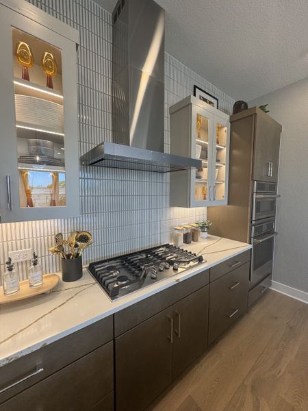 A modern kitchen with sleek cabinetry, stainless steel appliances, and marble countertops. Luxurious and functional design.