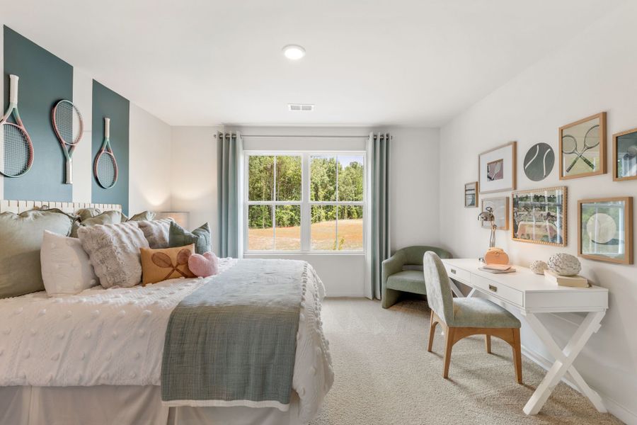 A bedroom with a bed and a table.