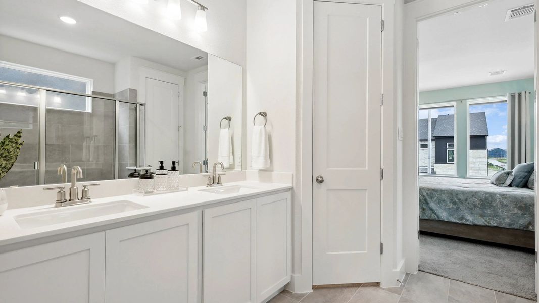 Experience refined luxury with dual sinks, chic cabinetry, and sleek fixtures in Collin Creek's elegant bathroom. Experience refined luxury with dual sinks, chic cabinetry, and sleek fixtures in Collin Creek's elegant bathroom.