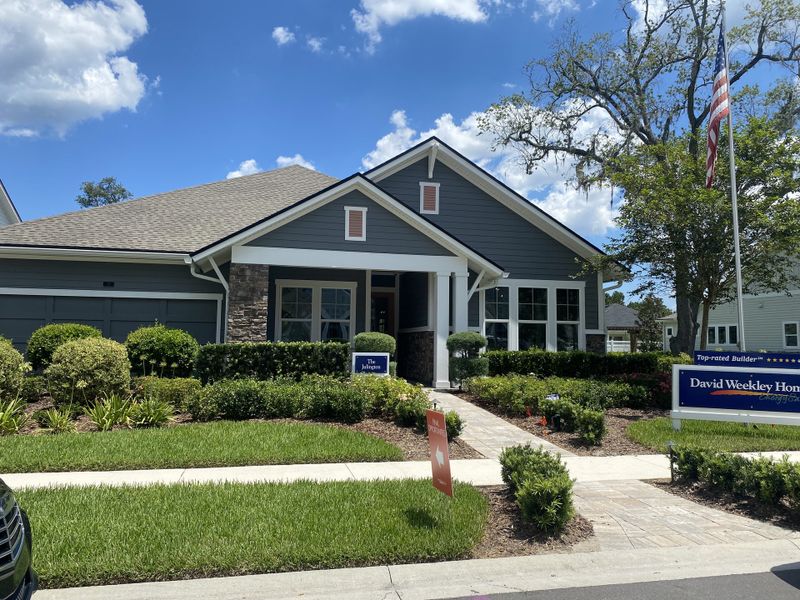 A charming gray home with elegant landscaping in Evergreen Island at Silverleaf by David Weekley Homes (St. Augustine, FL).
