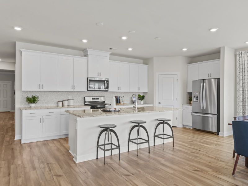 The large kitchen features stunning finishes and walk-in pantry.
