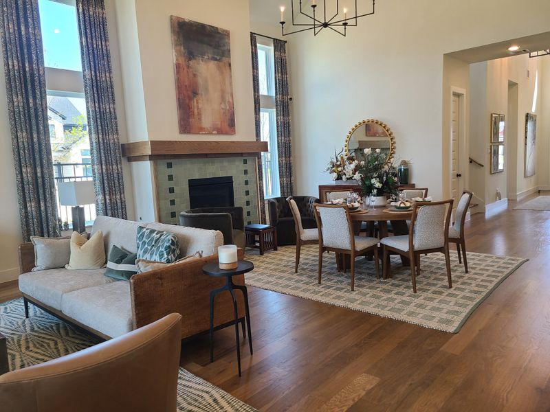 A spacious living-dining area with a cozy fireplace, elegant furnishings, and modern decor.