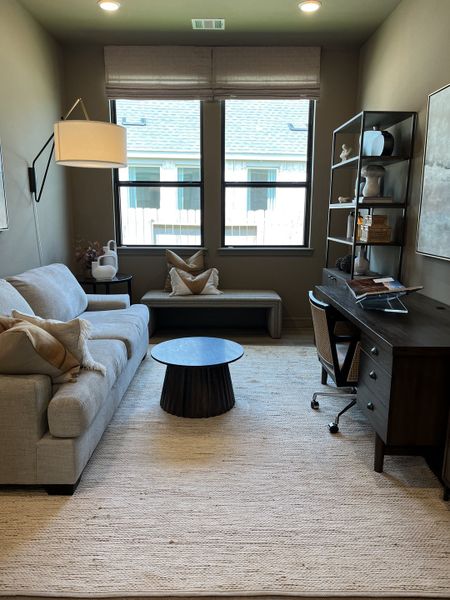 A cozy home office with a modern desk, comfy sofa, and sleek shelving, featuring soft lighting and neutral decor. A cozy home office with a modern desk, comfy sofa, and sleek shelving, featuring soft lighting and neutral decor.