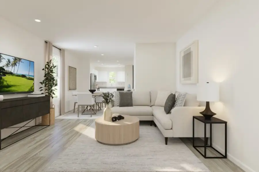 A living room with a large television.