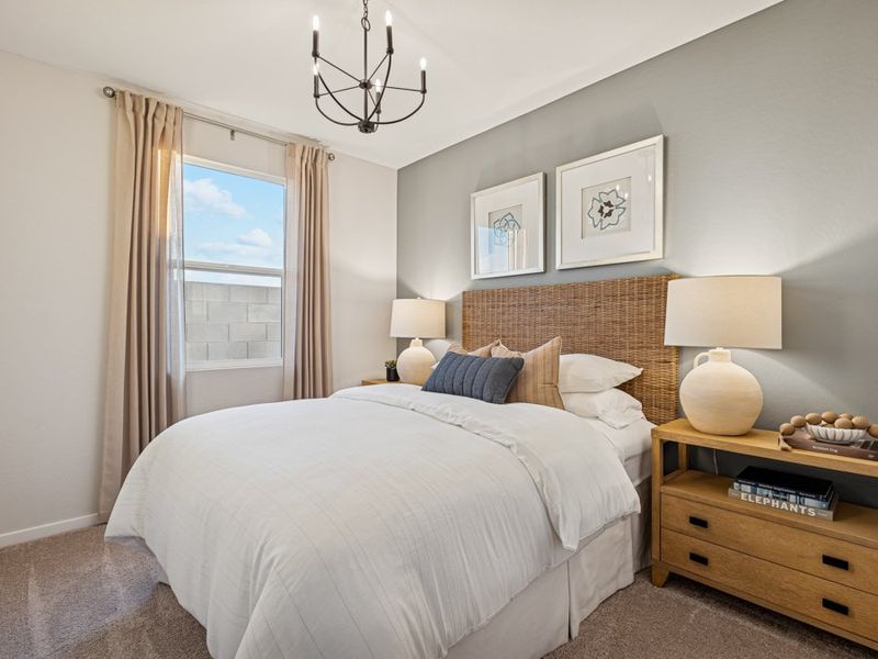 A bedroom with a bed and lamps.