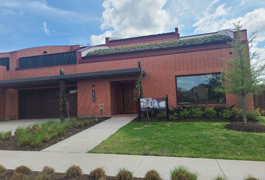 A modern brick home with unique roof landscaping in Tapestry by Total Environment Homes (Frisco, TX). A modern brick home with unique roof landscaping in Tapestry by Total Environment Homes (Frisco, TX).